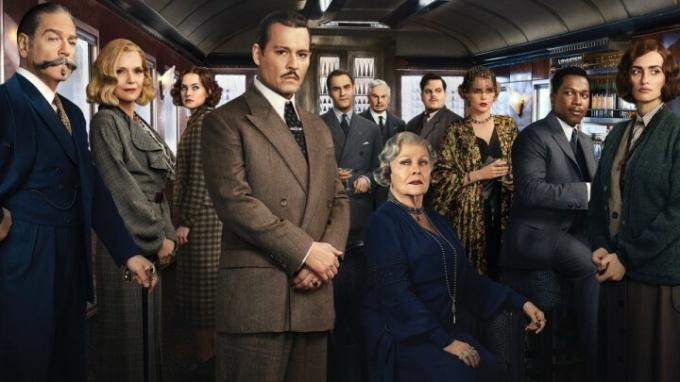 Rollelisten til Murder on the Orient Express poserer inne i et tog.