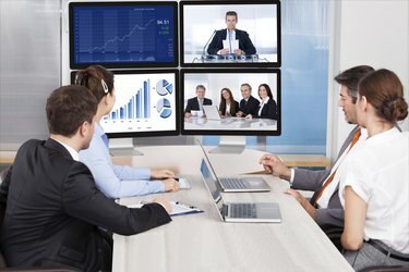 Uzņēmēji skatās uz datora ekrānu