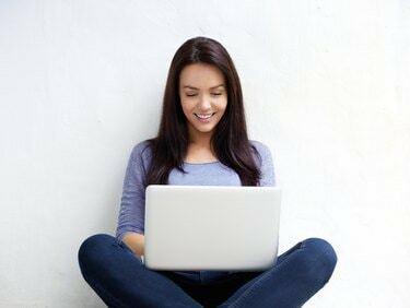Mulher jovem sorridente usando laptop