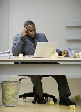 Афро-американский бизнесмен, глядя на ноутбук