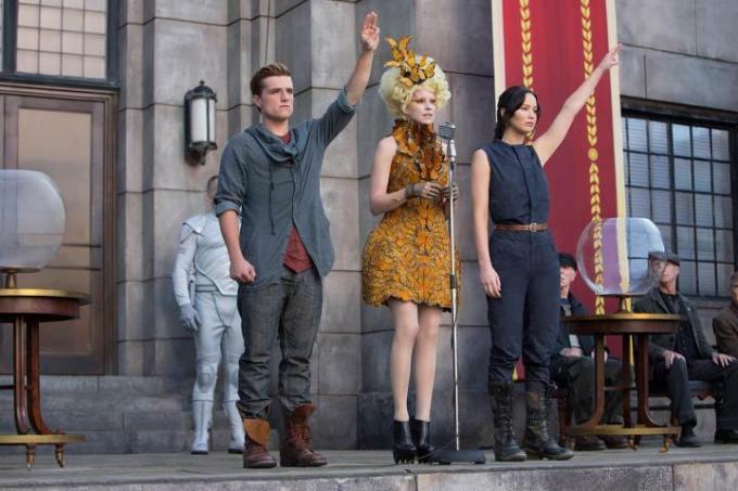 Karaktärer hälsar i en scen från The Hunger Games Catching Fire.