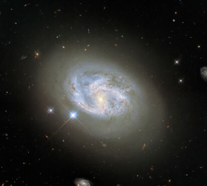 Esta imagen, tomada con la Cámara de Campo Amplio 3 del Hubble, muestra la galaxia espiral NGC 4680. Otras dos galaxias, en el extremo derecho y en la parte inferior central de la imagen, flanquean a NGC 4680. NGC 4680 disfrutó de una ola de atención en 1997, ya que fue sede de una explosión de supernova conocida como SN 1997bp. El astrónomo aficionado australiano Robert Evans identificó la supernova y ha identificado la extraordinaria cantidad de 42 explosiones de supernova. 