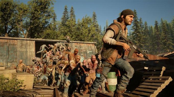 Days Gone's Deacon rennt vor einer Horde Zombies davon.