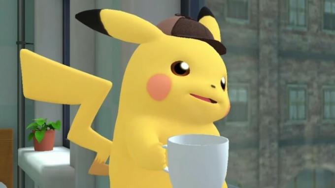 Pikachu z detektivsko kapo se smeje in pije skodelico kave