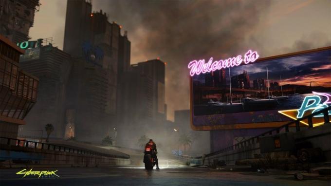 Seorang karakter mengendarai sepeda motor menyusuri jalan kosong di Cyberpunk 2077. 