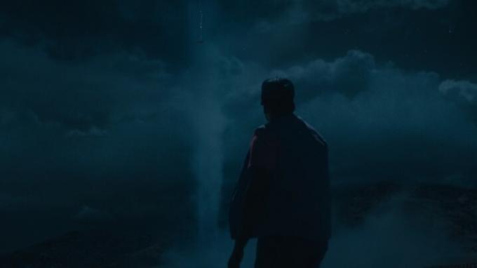 ينظر دانييل كالويا إلى السحابة القمعية في سماء الليل في مشهد من فيلم كلا.