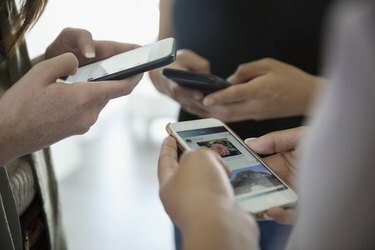 Cerrar amigas adolescentes usando teléfonos celulares