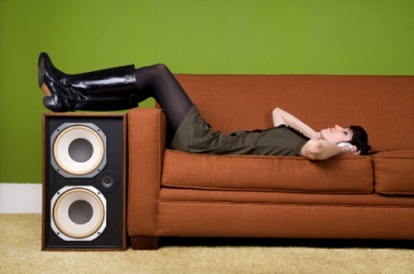 Ženske poslušajo slušalke na kavču