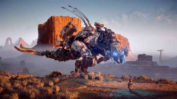 En robot står högt i Horizon Zero Dawn.