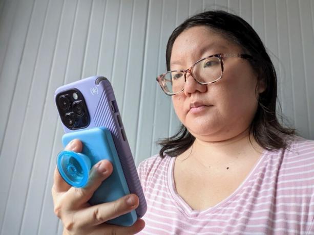 Christine Romero-Chan usando seu iPhone 14 Pro com uma bateria Anker PopSocket acoplada