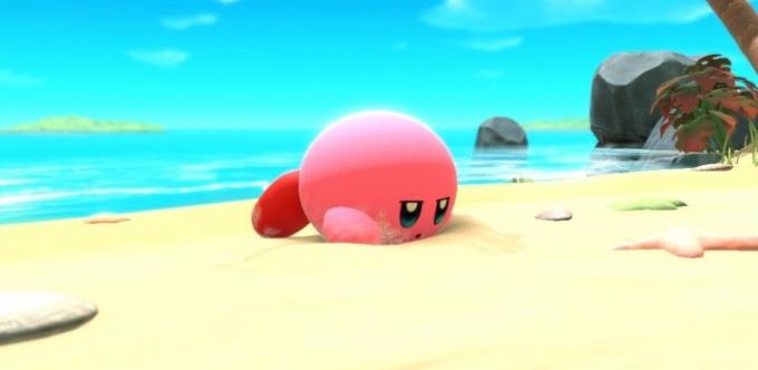 Ο Kirby ξαπλώνει στην παραλία στο Kirby and the Forgotten Lands.