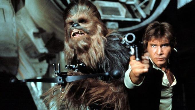 Chewbacca e Han Solo apontando armas.