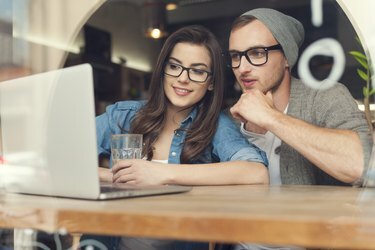 Двойка, наслаждаваща се на безжичен интернет в кафенето
