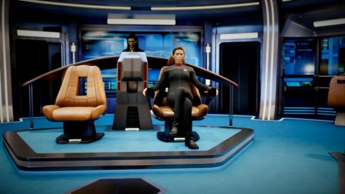 Kapitan USS Resolute sedi na stolu v Star Trek Resurgence. 