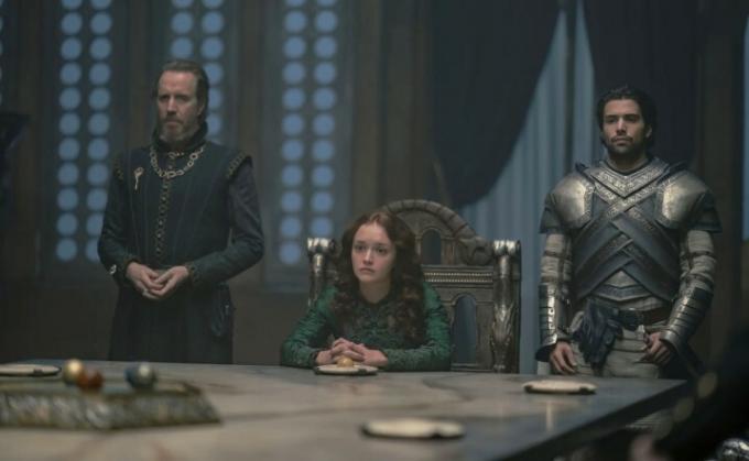 House of the Dragon'da bir kadın ve iki adam bir masada oturuyorlar.
