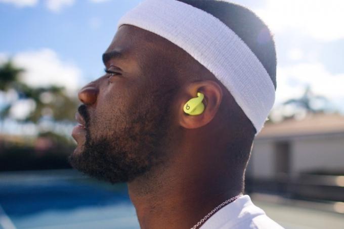 Petenis profesional Frances Tiafoe terlihat mengenakan Beats Fit Pro dalam warna Volt Yellow.