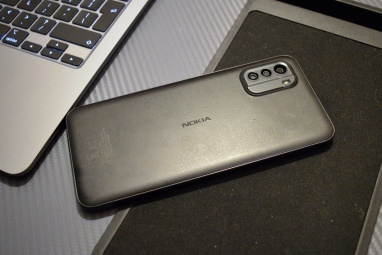 Nokia G60 5G položená lícem dolů na přenosný počítač.