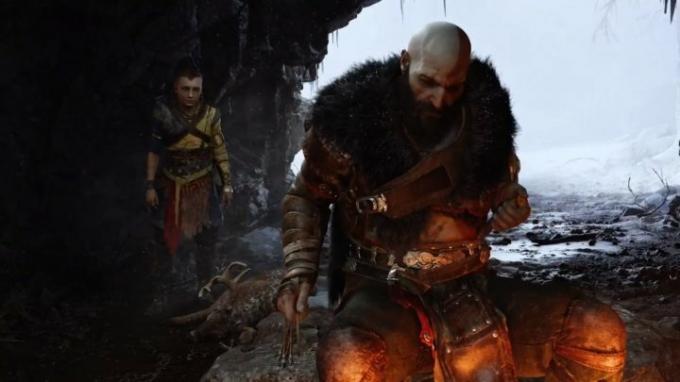 Kratos en zijn zoon zitten bij een vuur in God of War Ragnarok.