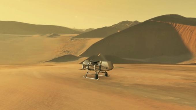 Den här illustrationen visar NASA: s Dragonfly-rotorcraft-landare närmar sig en plats på Saturnus exotiska måne, Titan. Genom att dra nytta av Titans täta atmosfär och låga gravitation kommer Dragonfly att utforska dussintals platser över hela den isiga världen, ta prover och mäta sammansättningar av Titans organiska ytmaterial för att karakterisera beboeligheten i Titans miljö och undersöka utvecklingen av prebiotika kemi.