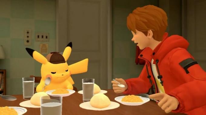 Pikachu z detektivsko kapo in fant z rjavimi lasmi in rdečo jakno zajtrkuje