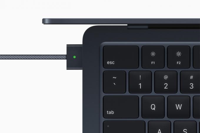 En toppvy av M2 MacBook Air som visar dess tangentbord och MagSafe-laddare.