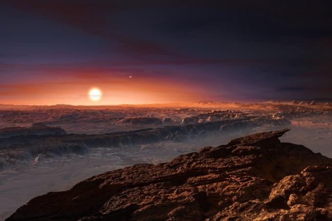 Bu sanatçının izlenimi, Güneş Sistemine en yakın yıldız olan kırmızı cüce yıldız Proxima Centauri'nin yörüngesindeki Proxima b gezegeninin yüzeyinin bir görüntüsünü gösteriyor. Çift yıldız Alpha Centauri AB de görüntüde görünüyor. Proxima b, Dünya'dan biraz daha ağırdır ve Proxima Centauri çevresinde, yüzeyinde sıvı su bulunması için sıcaklığın uygun olduğu yaşanabilir bölgede yörüngede döner.