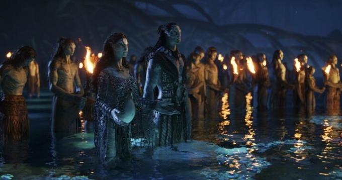 『アバター：ザ・ウェイ・オブ・ウォーター』の一場面で、ナヴィ族の群衆が水の中に立っています。